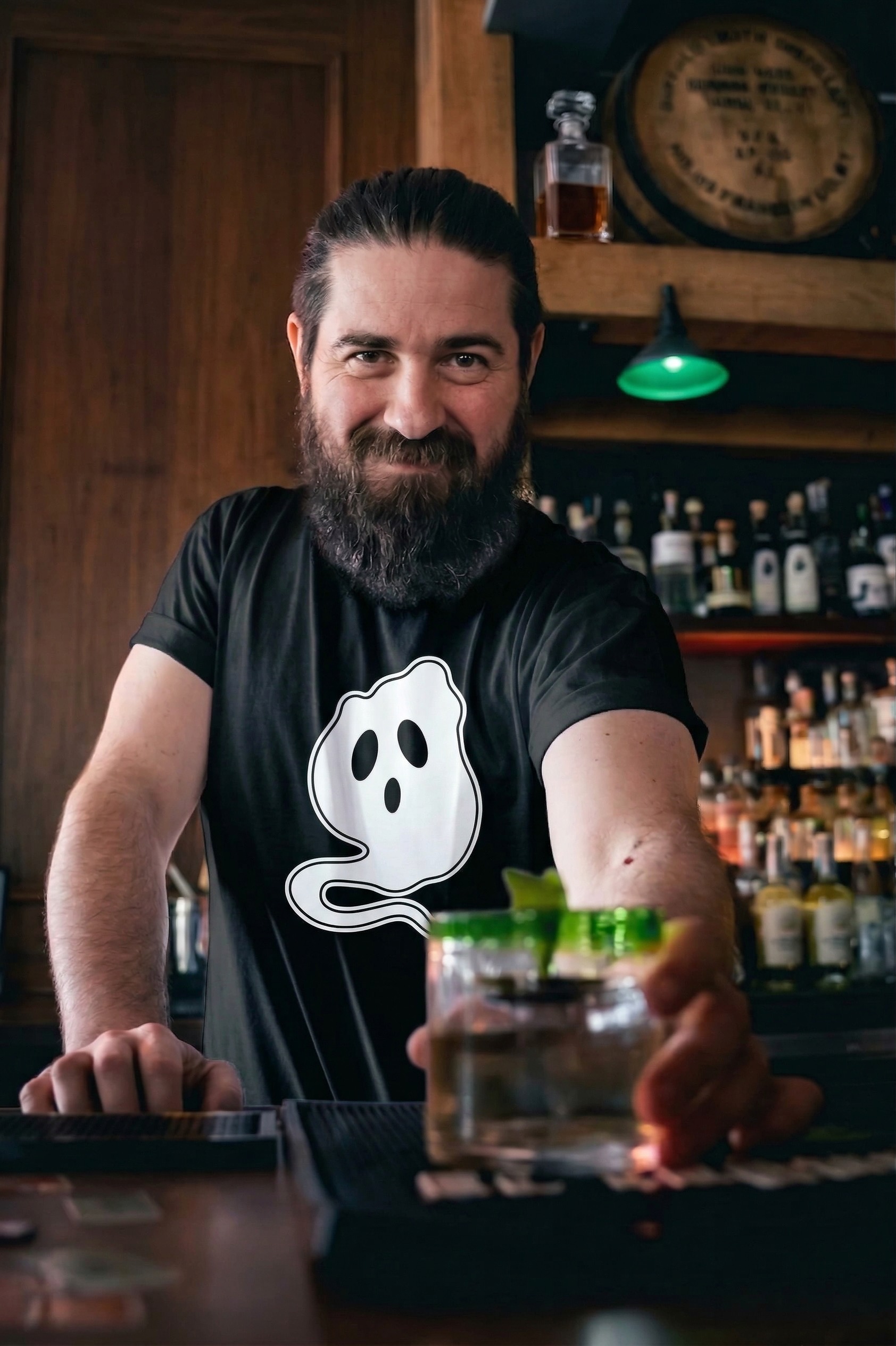 Rob serving a cocktail behind the bar